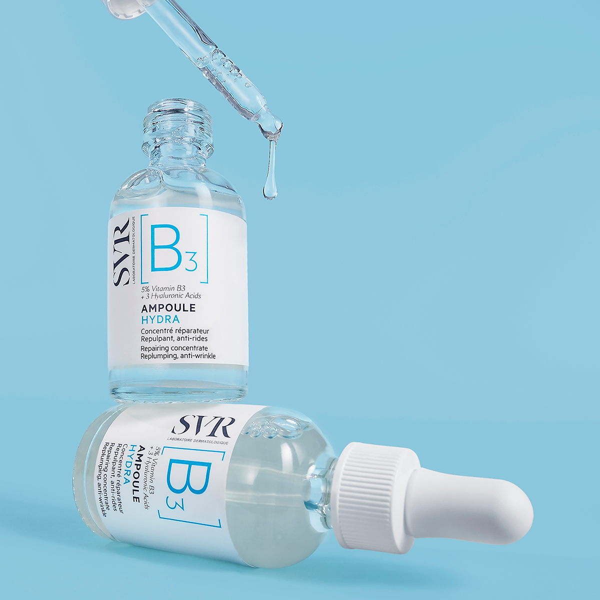 SVR Ampoule B3 Hydra serum bottles with glass dropper on a light blue background.