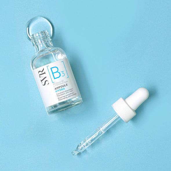 SVR Ampoule B3 Hydra serum bottle with a glass dropper on a light blue background.
