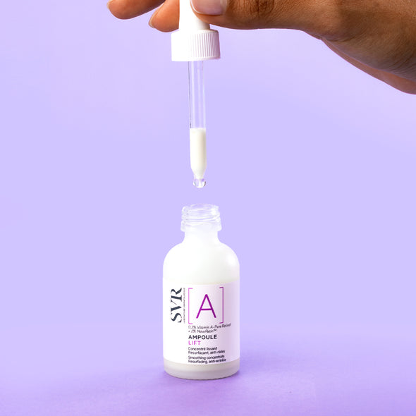 SVR Ampoule A Lift serum bottle with a white dropper dispensing white liquid against a solid purple background.