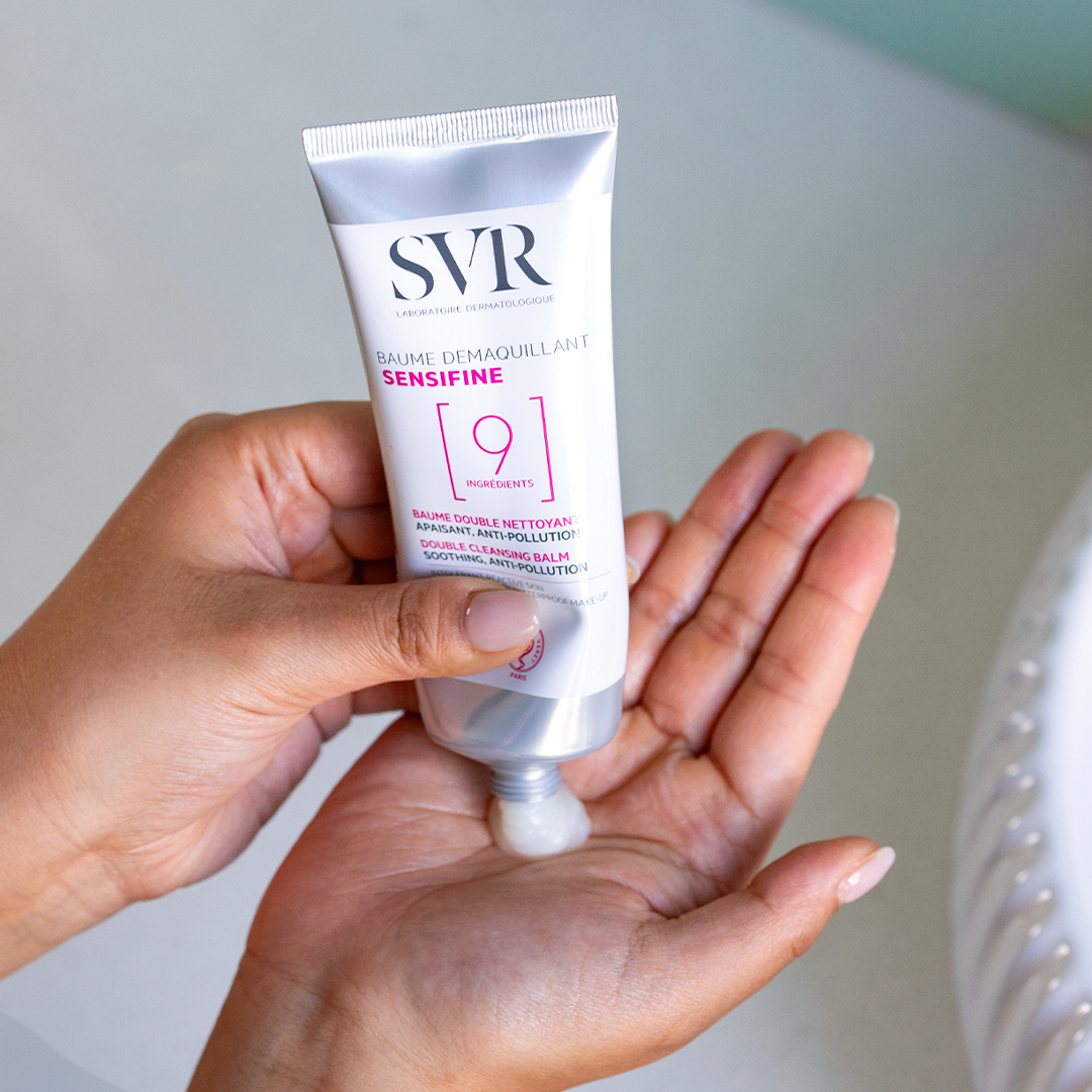 SVR Sensifine cleansing balm being squeezed from a silver tube into a palm.