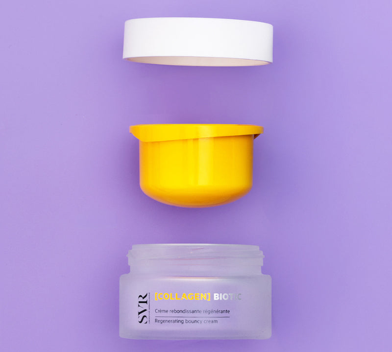 Open jar of SVR Collagen Biotic face cream with white lid and bright yellow inner seal on purple background.