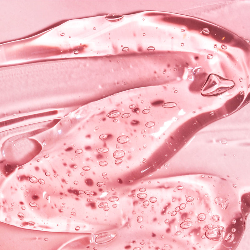Clear pink gel texture with small air bubbles, smooth and glossy surface.