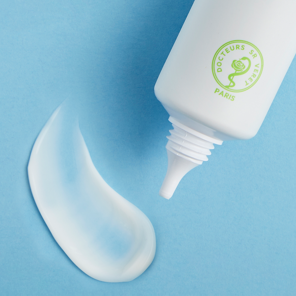 White squeeze tube of Sebiaclear Mat+Pores Cream with cream swatch on blue background.