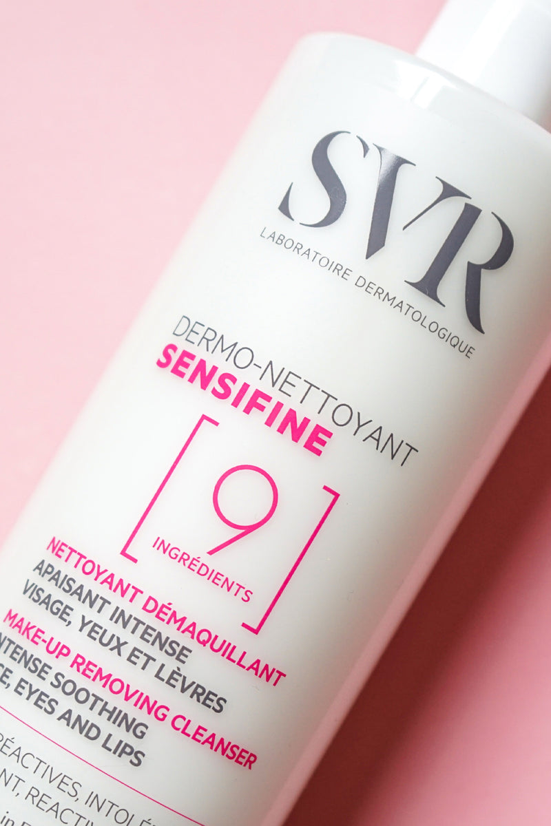 White pump bottle of SVR Sensifine Dermo-Cleanser with pink and grey text on pink background.