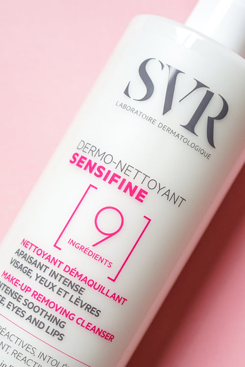 White pump bottle of SVR Sensifine Dermo-Cleanser with pink and grey text on pink background.
