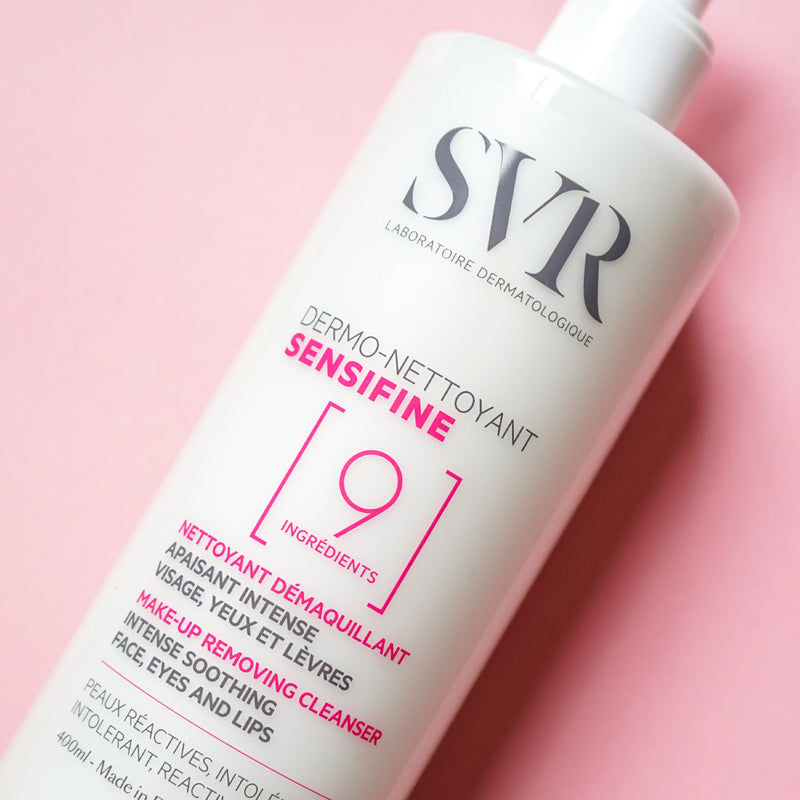 White pump bottle of SVR Sensifine Dermo-Cleanser with pink and grey text on pink background.
