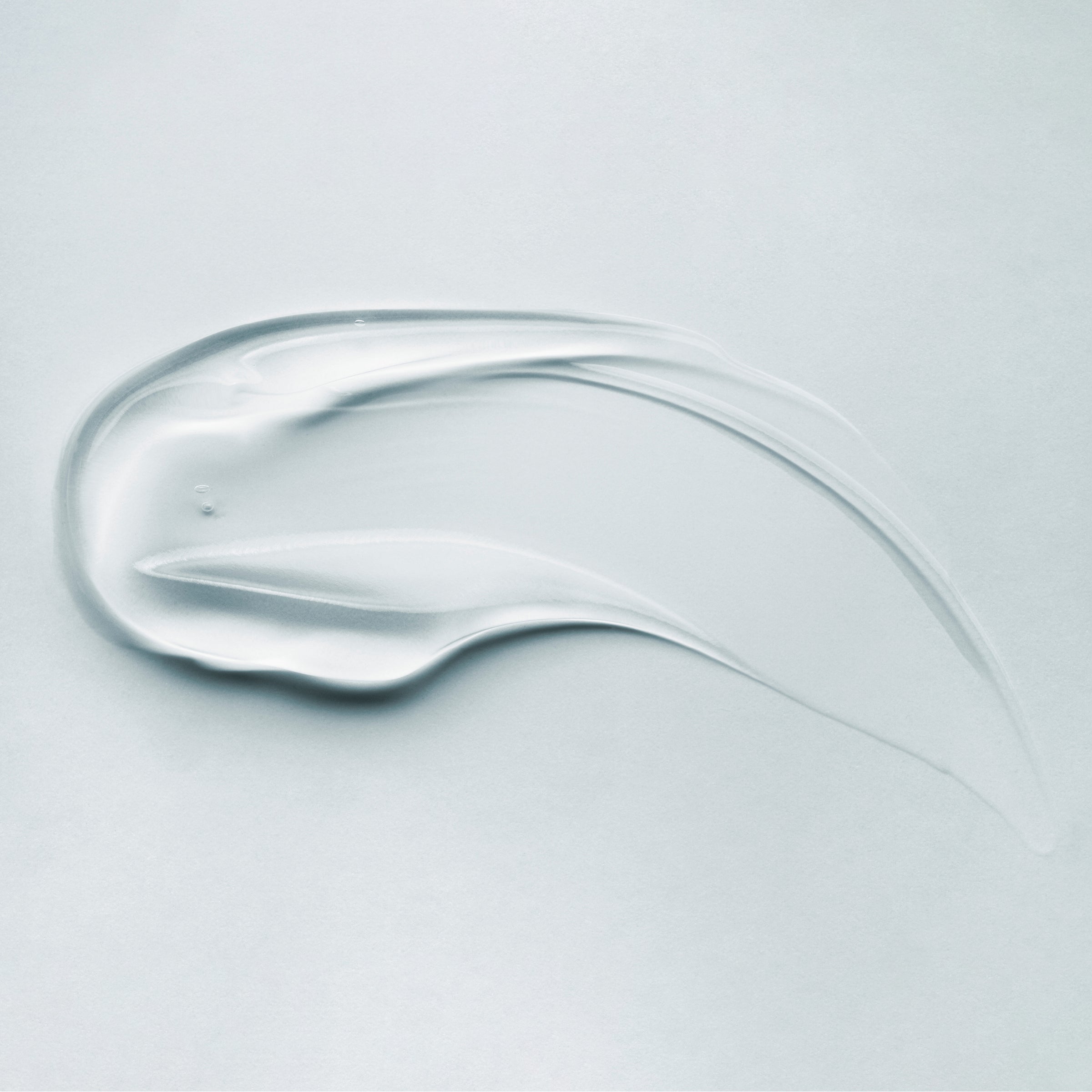 Clear, smooth smear of SEBIACLEAR Foaming Gel showing a lightweight, translucent texture on a light background.