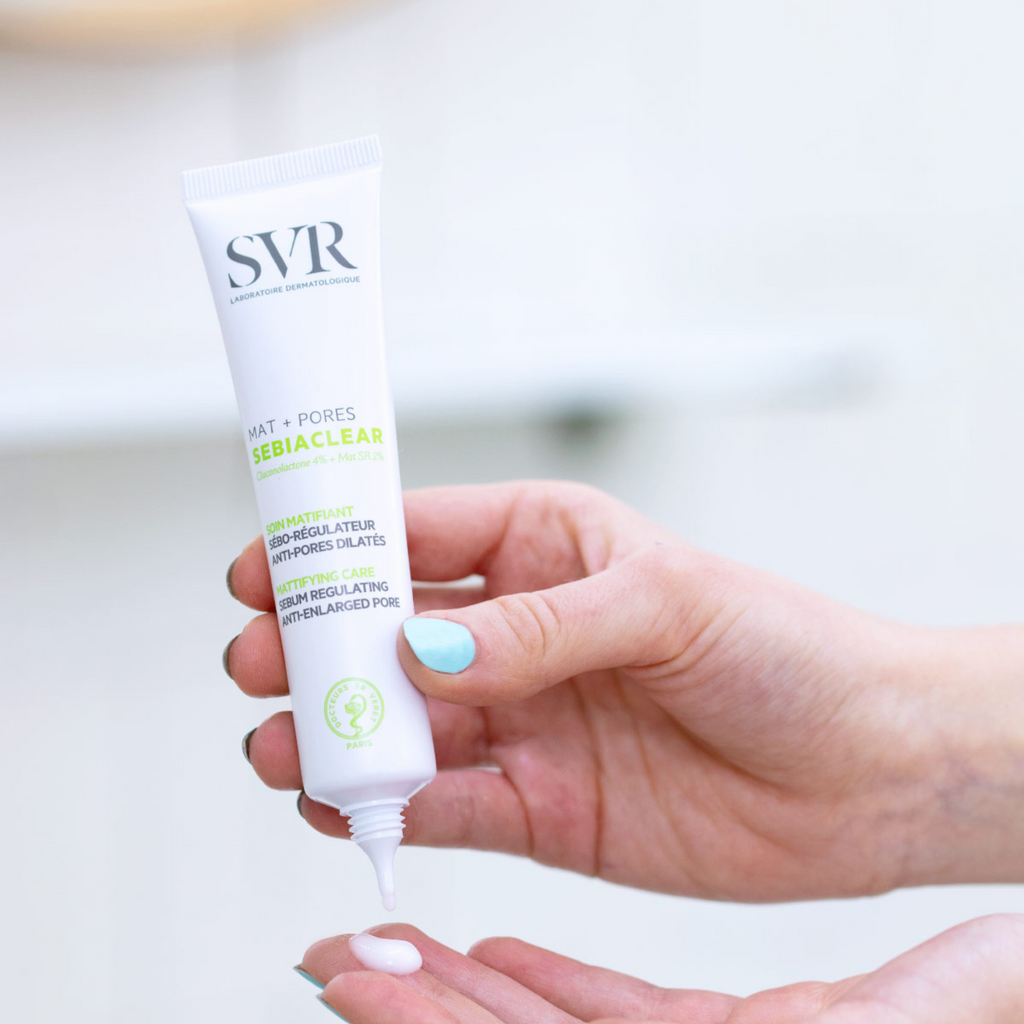 SVR Sebiaclear Mat+Pores cream tube with white cap held by hand dispensing cream on fingertip.