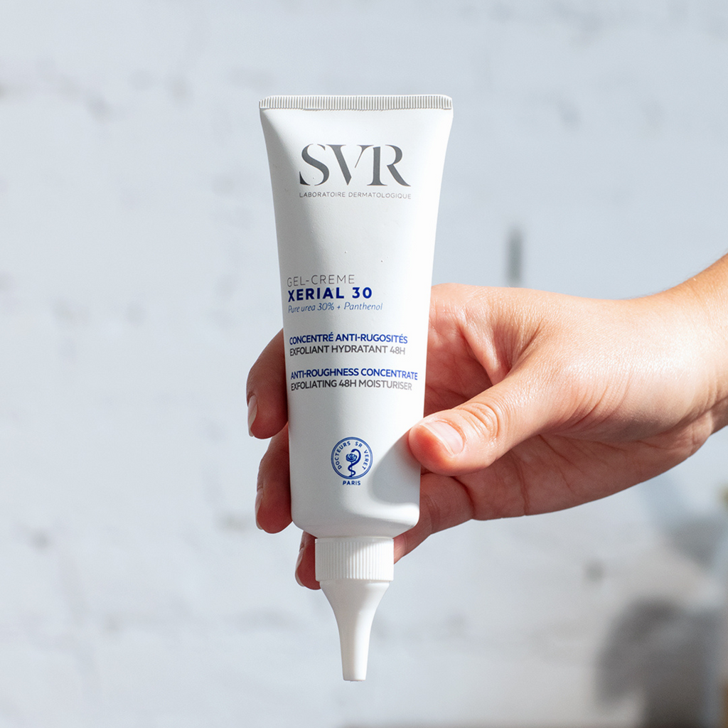 SVR XERIAL 30 Concentrated Cream white tube with blue and black text held by hand against light background.