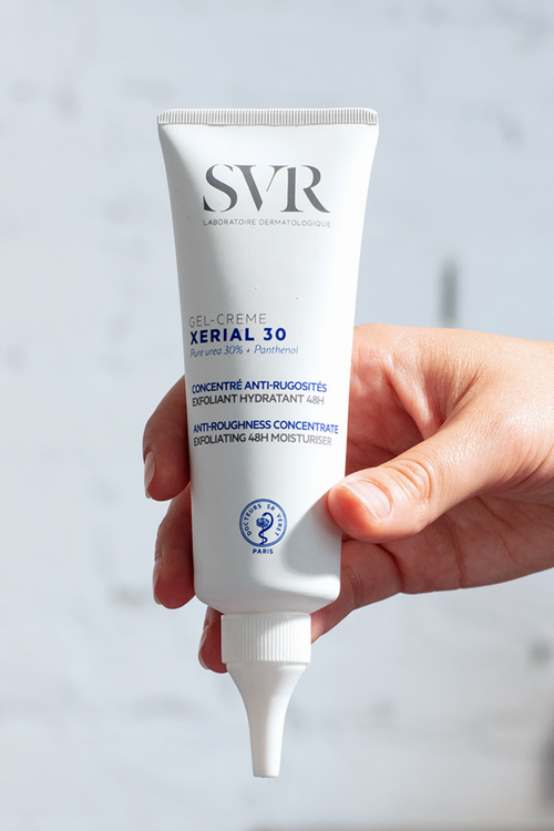 SVR XERIAL 30 Concentrated Cream white tube with blue and black text held by hand against light background.