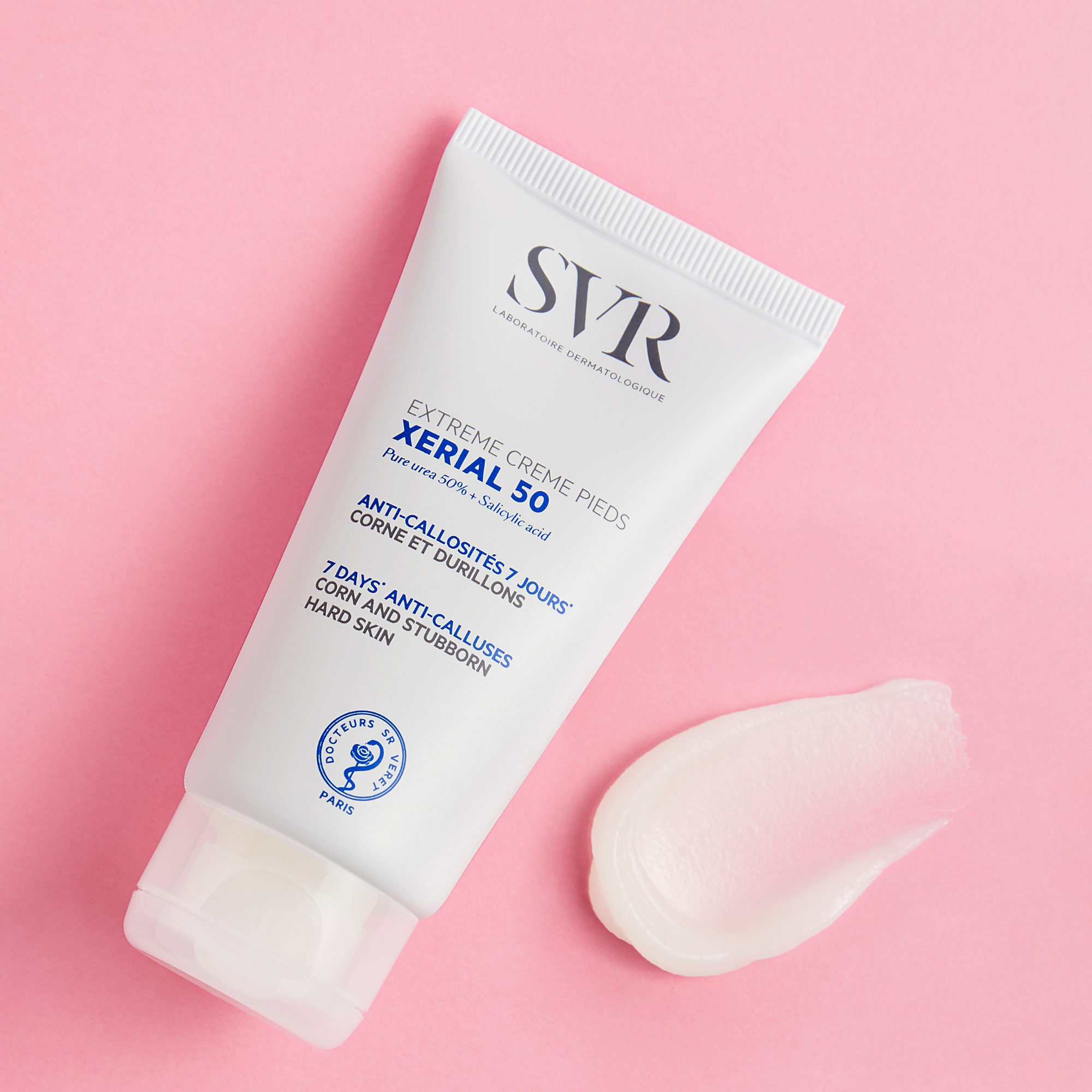 SVR Xerial 50 Extreme Foot Cream white tube next to a smooth cream swatch on pink background.