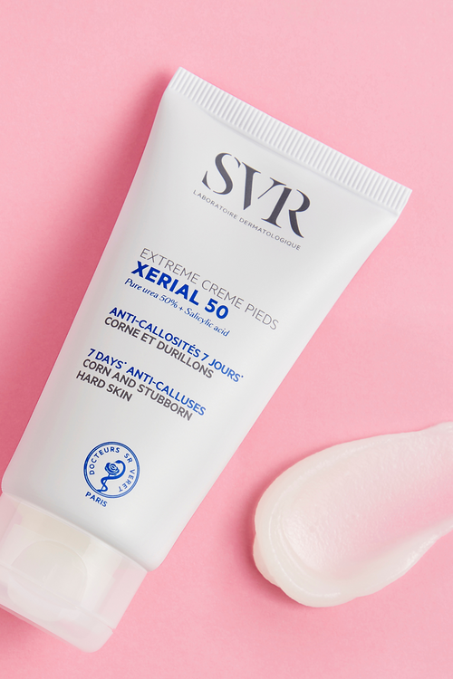 SVR Xerial 50 Extreme Foot Cream white tube next to a smooth cream swatch on pink background.